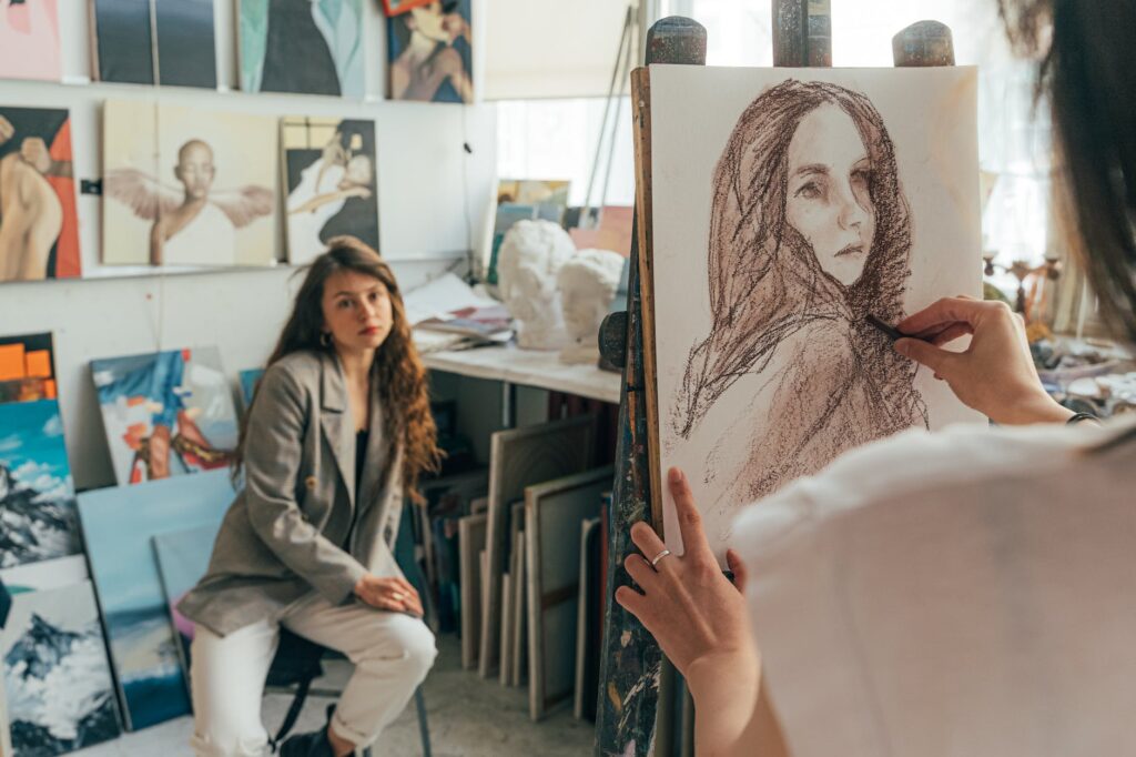 an artist drawing a woman s portrait